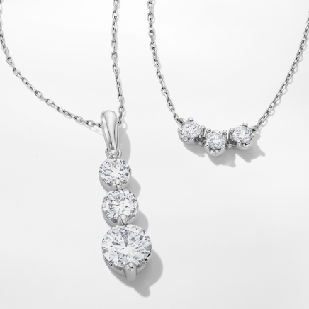 Image of two three stone diamond necklaces